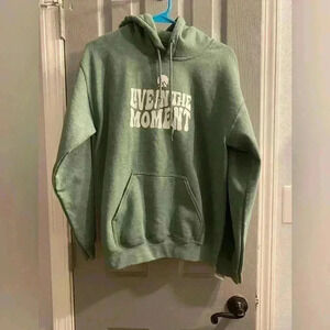 Unisex pullover sweatshirt hoodie with LIVE IN THE MOMENT in green with white
